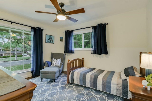 bedroom with wood finished floors, baseboards, and ceiling fan