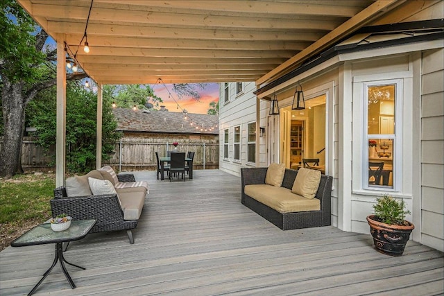 deck with a fenced backyard and outdoor dining area