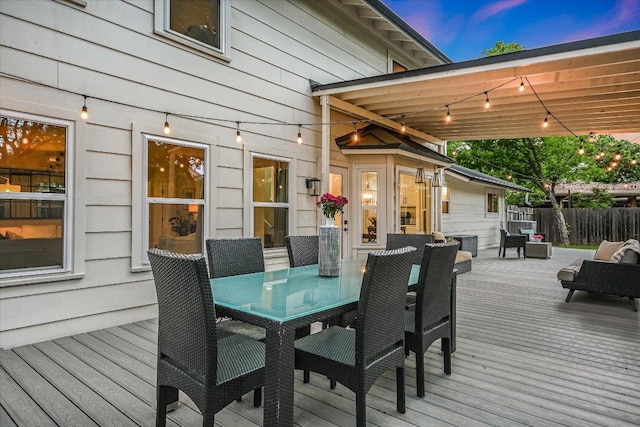 deck with outdoor dining space and fence