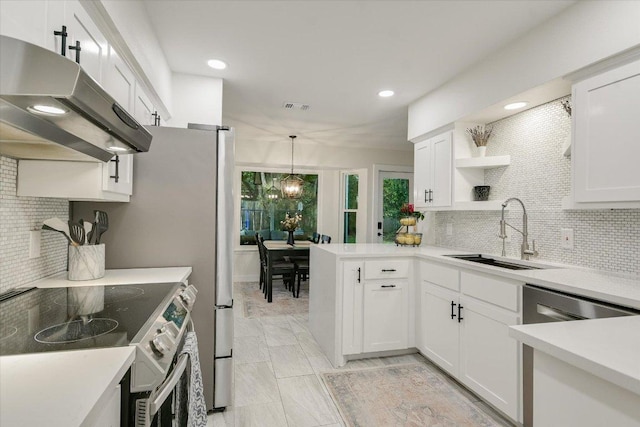 kitchen with under cabinet range hood, visible vents, a sink, decorative backsplash, and appliances with stainless steel finishes