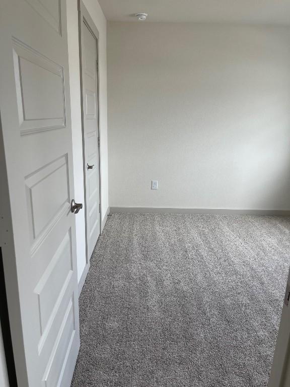 7500 Traylor Cv, Austin, TX 78724 - empty room with carpet, baseboards, and a smoke detector