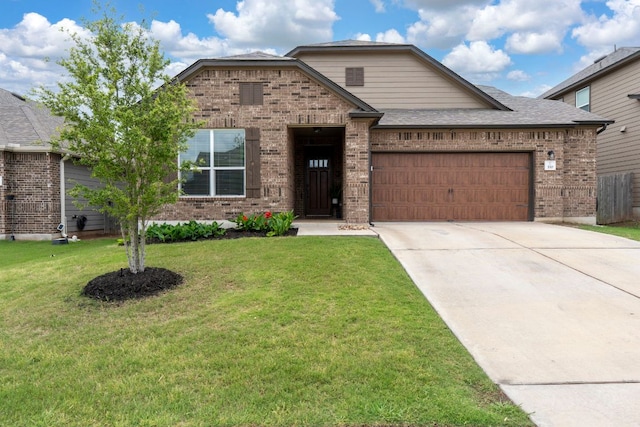 330 Conestoga Dr, Kyle, TX 78640 - view of front of house with brick siding, an attached garage, concrete driveway, a front lawn, and a shingled roof