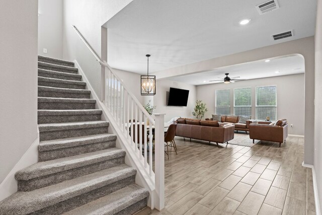 330 Conestoga Dr, Kyle, TX 78640 - stairs with ceiling fan, arched walkways, wood finish floors, and recessed lighting