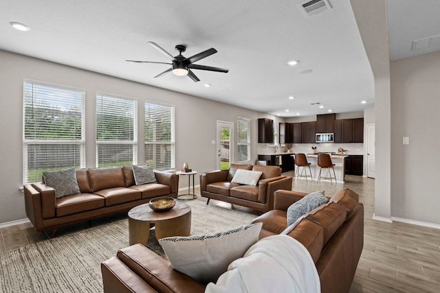330 Conestoga Dr, Kyle, TX 78640 - living area with ceiling fan, light wood finished floors, and recessed lighting