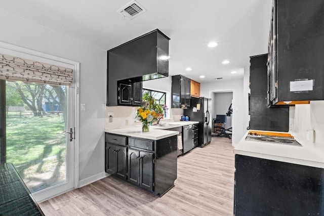 508 Explorer, Lakeway, TX 78734 - kitchen featuring black refrigerator with ice dispenser, dishwasher, light wood-style floors, light countertops, and recessed lighting