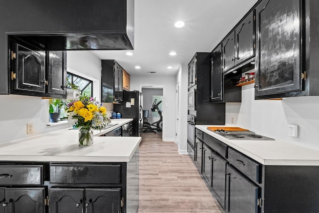 508 Explorer, Lakeway, TX 78734 - kitchen featuring electric stovetop, fridge with ice dispenser, dark cabinets, light wood-style floors, and light countertops