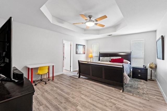 508 Explorer, Lakeway, TX 78734 - bedroom with a tray ceiling, wood finished floors, and a ceiling fan