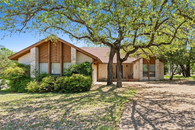 508 Explorer, Lakeway, TX 78734 - mid-century modern home featuring stone siding and a garage