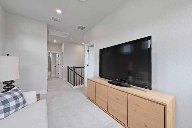 living area featuring visible vents, attic access, light carpet, and recessed lighting