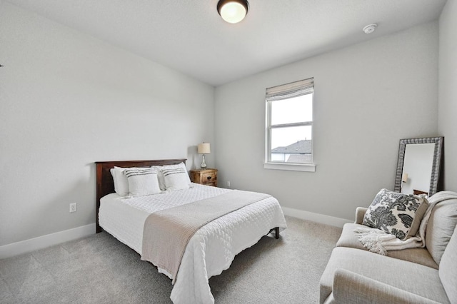 bedroom with carpet flooring and baseboards