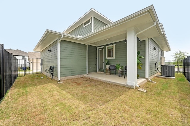 back of house featuring a lawn, central air condition unit, a patio area, and fence