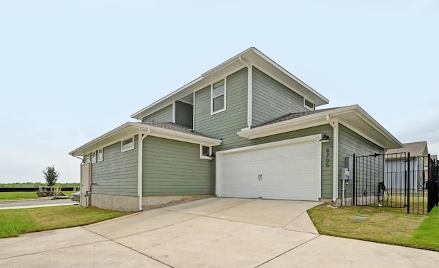 view of side of property with driveway, a garage, and fence
