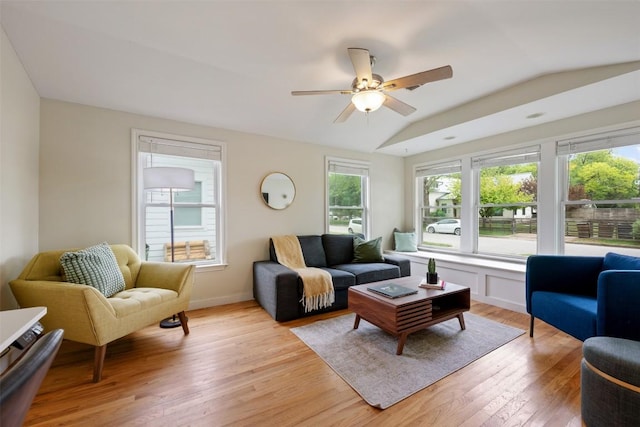 living area featuring light wood-type flooring, a ceiling fan, and vaulted ceiling