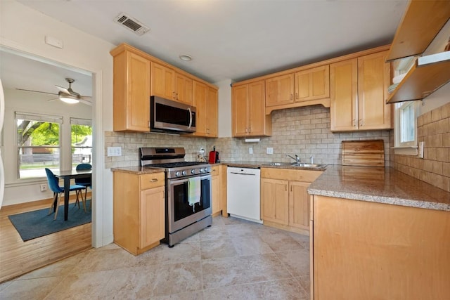 kitchen featuring a sink, light brown cabinetry, visible vents, and appliances with stainless steel finishes