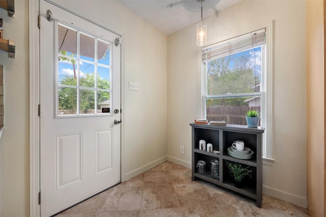 entryway featuring baseboards and plenty of natural light