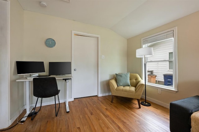 office space with baseboards, wood finished floors, and lofted ceiling