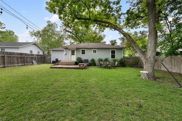 back of property featuring a deck, a yard, and a fenced backyard