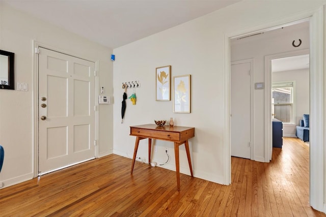 entryway featuring light wood-style floors and baseboards