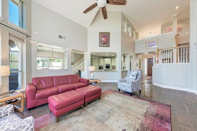 8236 Phantom Canyon Dr, Austin, TX 78726 - living area with ornate columns, high vaulted ceiling, a ceiling fan, wood finished floors, and stairs