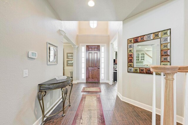 8236 Phantom Canyon Dr, Austin, TX 78726 - foyer entrance with dark wood-style flooring, ornate columns, and a textured wall