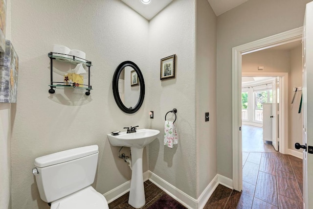 8236 Phantom Canyon Dr, Austin, TX 78726 - bathroom with toilet, baseboards, and wood finished floors
