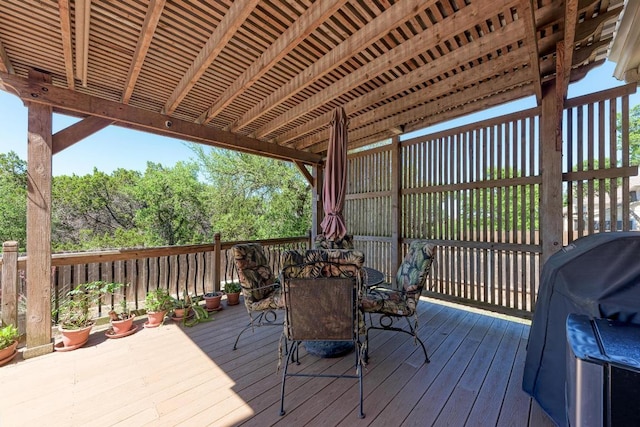deck featuring outdoor dining area and a grill