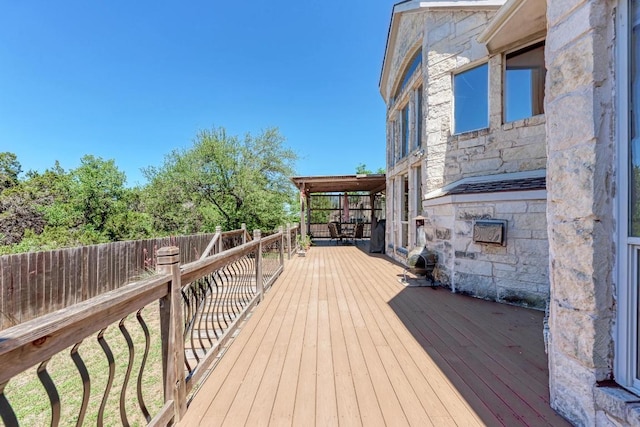 wooden terrace featuring fence