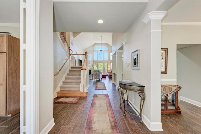 entrance foyer with stairs, decorative columns, and dark wood-type flooring