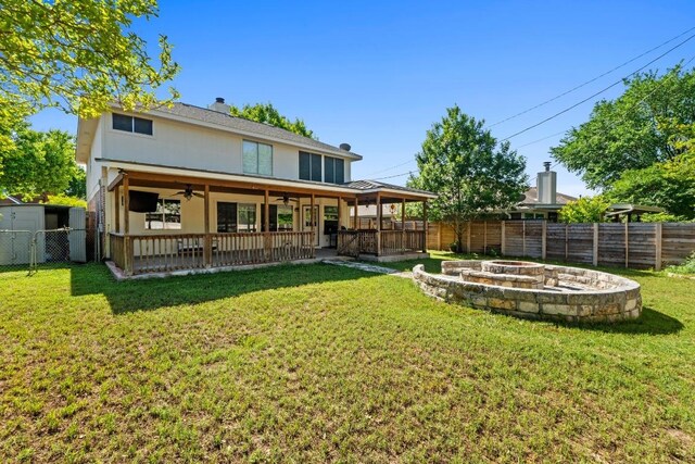 rear view of property with a patio, a fire pit, ceiling fan, and a fenced backyard