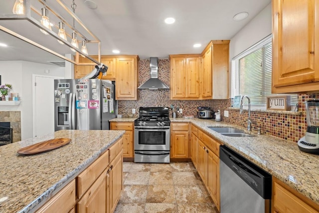 kitchen with a sink, stainless steel appliances, decorative backsplash, wall chimney exhaust hood, and light stone counters