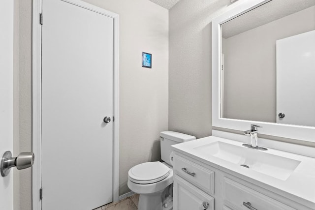 half bath featuring toilet and vanity