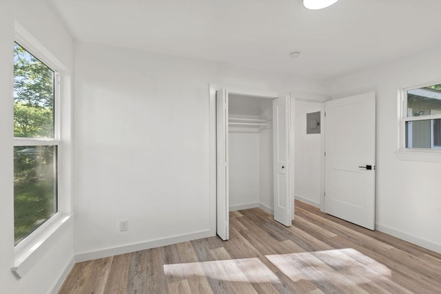 502 Oakley Ct, Austin, TX 78753 - unfurnished bedroom with wood finished floors, baseboards, a closet, and electric panel