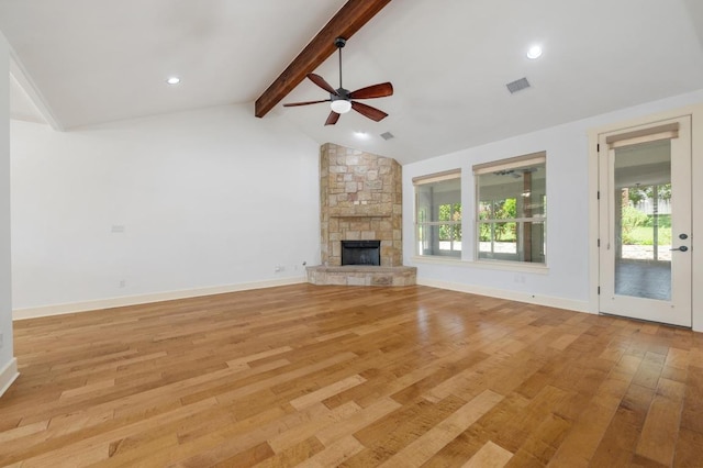 unfurnished living room with a fireplace, lofted ceiling with beams, ceiling fan, visible vents, and light wood-style flooring