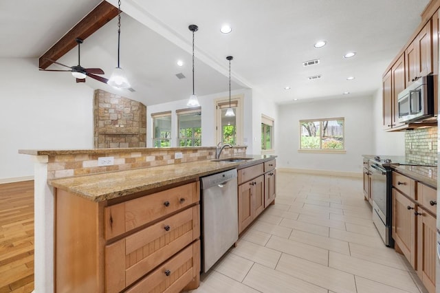 kitchen featuring decorative backsplash, a sink, stainless steel appliances, baseboards, and a ceiling fan