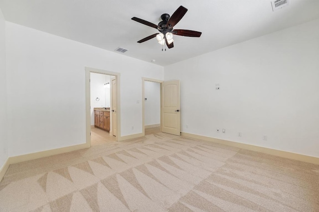 unfurnished bedroom with visible vents, light colored carpet, and baseboards