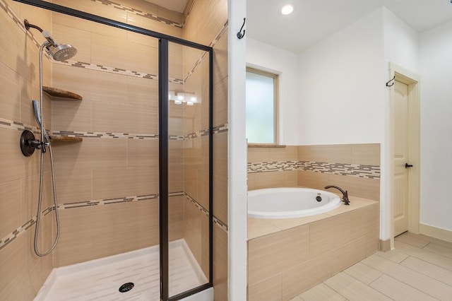 bathroom featuring a garden tub, recessed lighting, and a shower stall