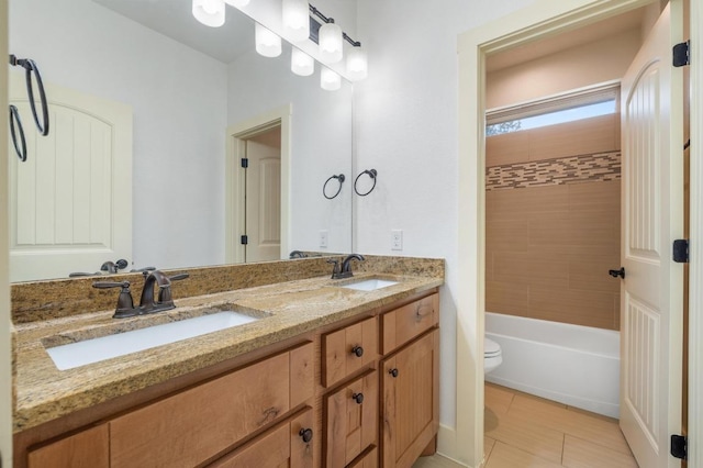 full bath with double vanity, toilet, and a sink