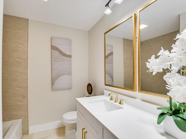 full bathroom featuring toilet, vanity, tile patterned floors, and baseboards
