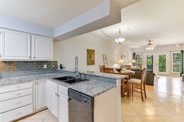 kitchen with a sink, light tile patterned flooring, open floor plan, black dishwasher, and a peninsula