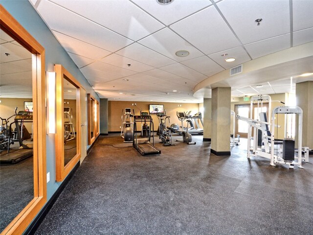 gym featuring a paneled ceiling and visible vents