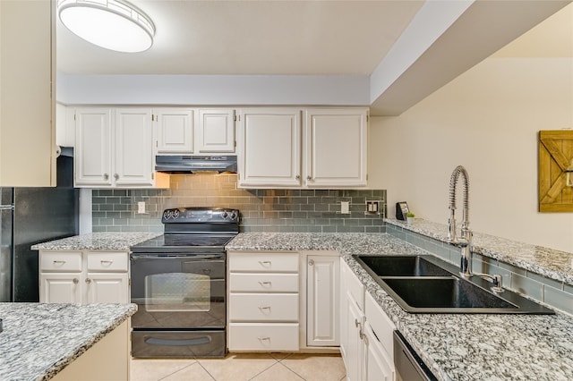 kitchen with a sink, under cabinet range hood, light tile patterned flooring, black / electric stove, and tasteful backsplash