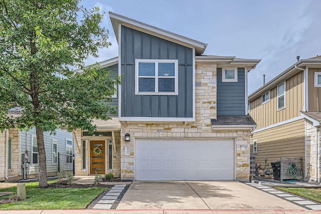 1513 Casa Dr, Austin, TX 78745 - view of front facade featuring board and batten siding, a garage, stone siding, and concrete driveway