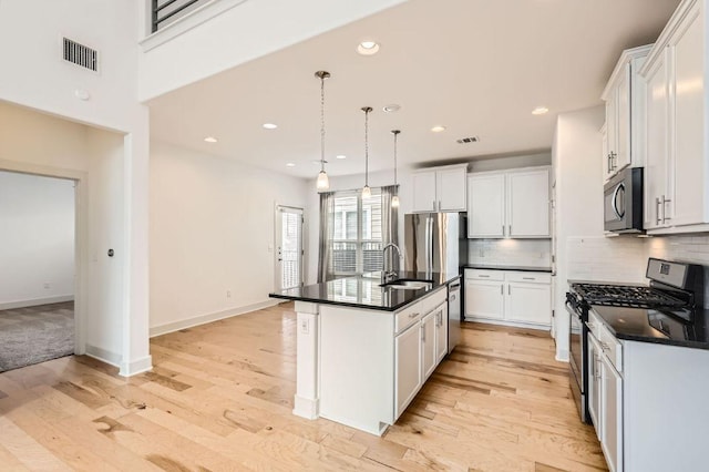 1513 Casa Dr, Austin, TX 78745 - kitchen with stainless steel appliances, a sink, dark countertops, decorative backsplash, and light wood-type flooring