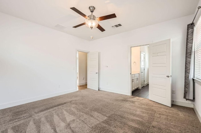 1513 Casa Dr, Austin, TX 78745 - unfurnished bedroom with carpet flooring, baseboards, connected bathroom, and ceiling fan