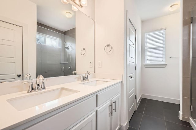 1513 Casa Dr, Austin, TX 78745 - bathroom featuring a shower stall, double vanity, tile patterned flooring, and baseboards