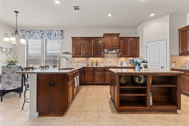 2812 Saint Rodrigo Ct, Round Rock, TX 78665 - kitchen featuring open shelves, under cabinet range hood, tasteful backsplash, light stone countertops, and recessed lighting