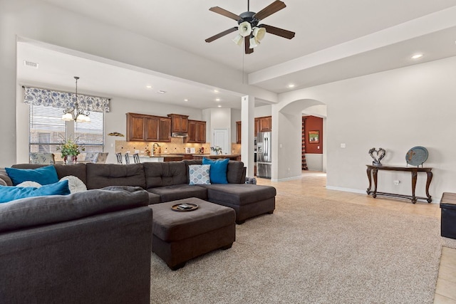2812 Saint Rodrigo Ct, Round Rock, TX 78665 - living area with arched walkways, a ceiling fan, light tile patterned flooring, recessed lighting, and a chandelier