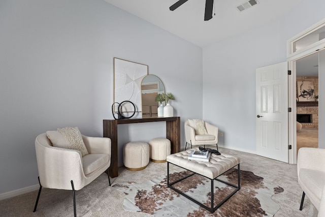 2129 Aaron Ross Way, Round Rock, TX 78665 - living area featuring a ceiling fan, carpet flooring, and a fireplace