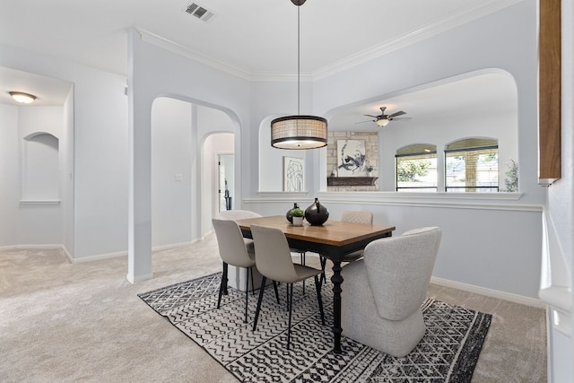 2129 Aaron Ross Way, Round Rock, TX 78665 - carpeted dining area with arched walkways, a ceiling fan, and ornamental molding