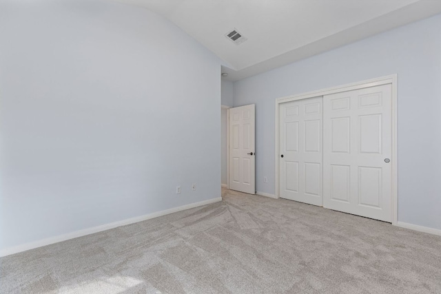 2129 Aaron Ross Way, Round Rock, TX 78665 - unfurnished bedroom with carpet floors, vaulted ceiling, and a closet